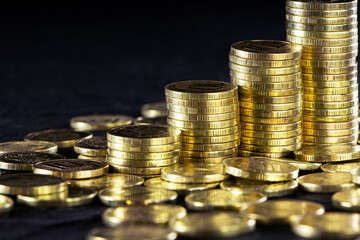 A stack of gold coins isolated on a black background.Money on a black background.Finance and money