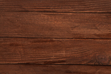 Vintage colored wood background texture with knots and nail holes. Old painted wood wall. Brown abstract background. Vintage wooden dark horizontal boards. Front view with copy space