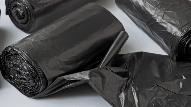 New black garbage bags on a white background.