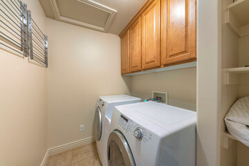 Small laundry room interior with wall-mounted drying rack