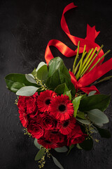 bouquet of red flowers on a black background