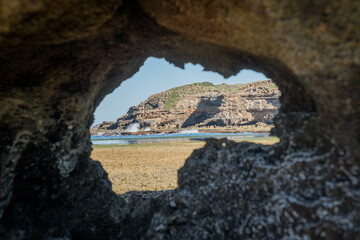 looking through rock to the ocean 