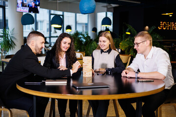 Businessmen are playing Jenga games. They sit in the office and play games. Concept photo for design and work.