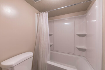 Interior of a bathroom with paneled acrylic wall on the shower tub