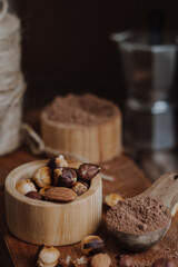 nuts and cacao powder on wooden background
