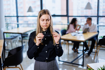 Young beautiful woman businesswoman suffers a headache from overwork. migraine at work