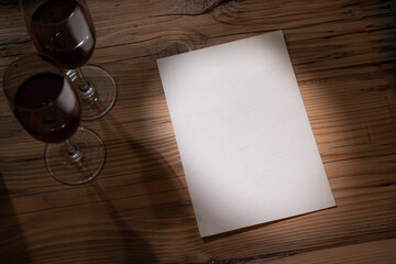 plane white paper with red wine glasses on wood table