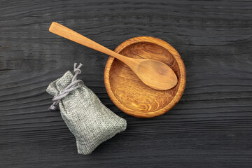 Wooden utensils are not a black table. Spoon and plate.