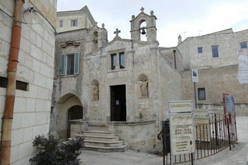 St. Biagio church in Matera, the facade made by white sandstone with the staircase in front of the entrance door and the bell tower.