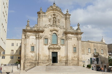 Saint Francis church in Matera, the facade in baroque style made by white sandstone  with the staircase in front of the entrance door and the decorations.