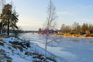 Landscape with a frozen river in the winter.