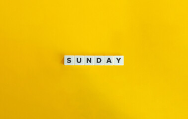 Sunday Word on Letter tiles on yellow background. Minimal aesthetics.