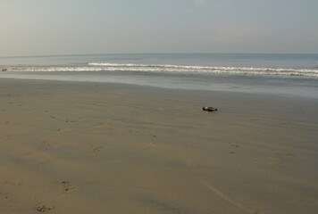 view from the sandy beach with a bottle in the foreground