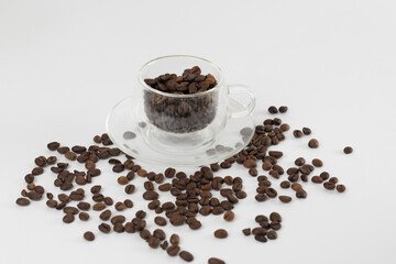 Coffee beans on a white background. Cup of coffee beans.