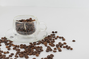Coffee beans on a white background. Cup of coffee beans.