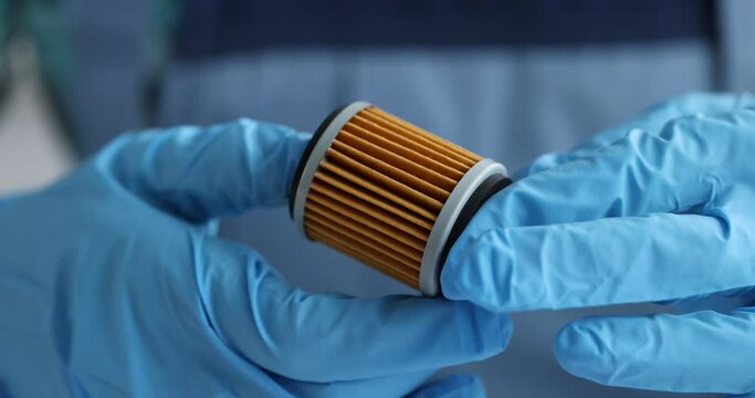 Master repairman holding new oil filter for auto closeup 4k movie