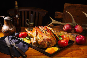 Traditional roasted stuffed Christmas duck with apples served as close-up on a rustic tray on a...