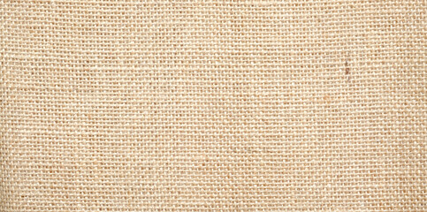 Hessian sackcloth burlap woven texture background / cotton woven fabric background with flecks of varying colors of beige and brown. with copy space. office desk concept.High Resolution horizontal .	