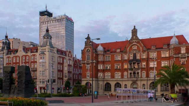 Katowice, Poland. View of historical and modern building in the center of Katowice, Poland in the evening. Time-lapse with the car and people traffic, panning video