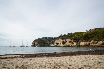 Fototapeta na wymiar Cala Macarelleta, Menorca. September 2021. Paradise beach on the island of Menorca. Perfect place to relax and enjoy nature in summer.
