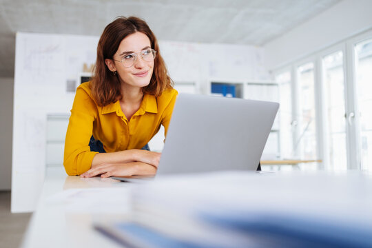 Young businesswoman looking aside deep in thought