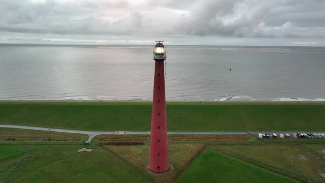 Lighthouse tower Lange Jaap in Den Helder drone aerial footage 5K along the sea near the island of Texel in North Holland, The Netherlands.