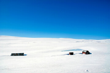 Houses in the snow covered plains of the Hardangervidda