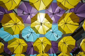 Fototapeta na wymiar Bright and colourful umbrellas forming a canopy