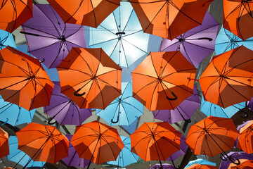Fototapeta na wymiar Bright and colourful umbrellas forming a canopy