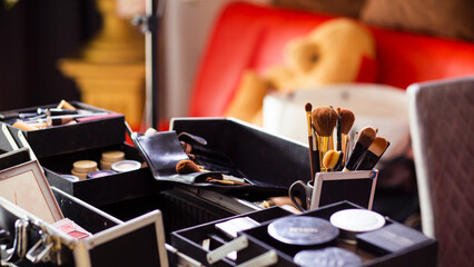 Dedicated focus Make-up converter on makeup artist's table with lots of makeup artist tools. The stack surrounds the makeup artist's table, leaving room for text.