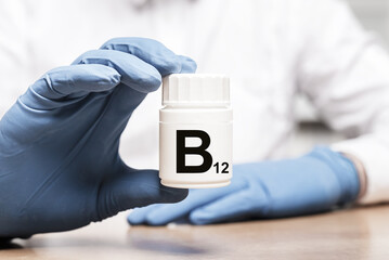 B 12 vitamin in hand in white jar. photo