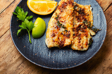 Fried fish fillets in orange oil.