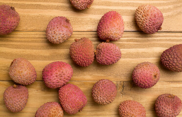 Lychee fruit on wooden background. Top view, flat lay