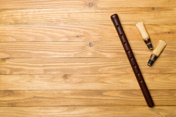 Armenian national musical instrument duduk on wooden background. Top view