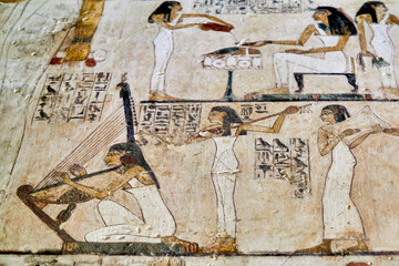 Colorful painting from and Ancient Egyptian tomb depicting female musicians, the first performing...