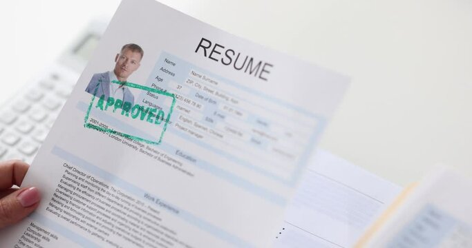 Manager hand holding document with resume for employment with stamp approved closeup 4k movie