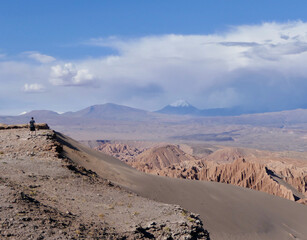 Fototapeta na wymiar Lonely hiker standing on canyon in Atacama desert mountain landscape with impressive view