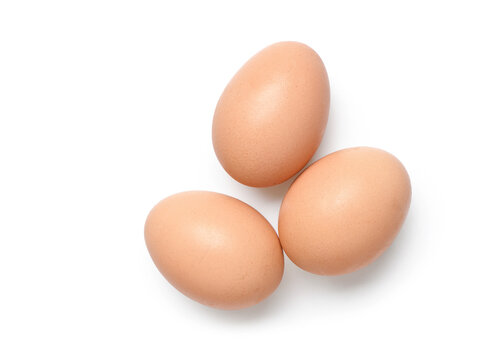 Flat lay of three chicken eggs isolated on white background. Clipping path.