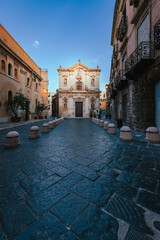 Naklejka premium Wide view of the Cathedral of San Cataldo in the old town of Taranto at sunrise with person, vertical