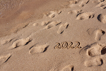 Inscription 2022 on the sand on the shores of the Red Sea.