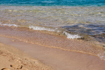 Waves on the tropical sandy beach of the red sea.