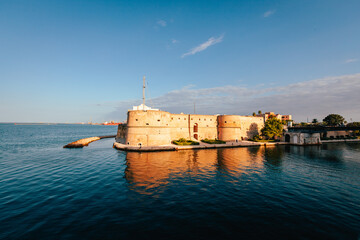 Castle by the sea, blue sky with clouds, Aragonese castle in Taranto