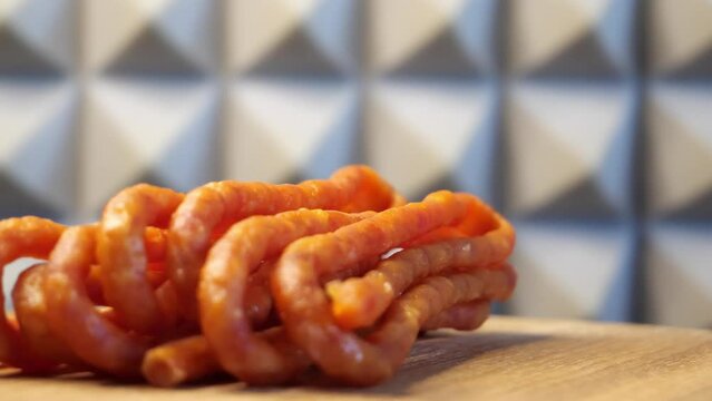 Traditional polish sausages kabanos on a rotating wooden surface. Macro.
