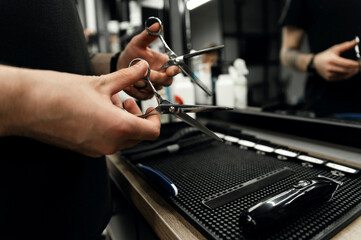 scissors in barber's hands. barbershop accessories