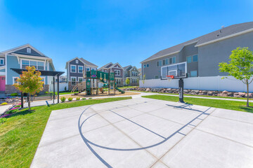 Single basketball court with black lines and lawn on the side