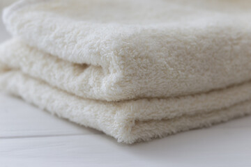 Fototapeta na wymiar White fluffy bath towels on the white background 