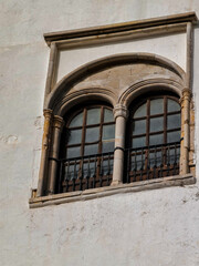 Two small windows protected with metallic railings in the old medina of Asilah