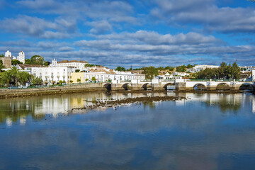 Fototapeta na wymiar seven-arched Roman Bridge over the Gilão River in Tavira, Algarve / Portugal
