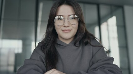 Young woman smiling and looking to cam
