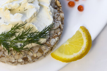 Crispy wheat crackers with red caviar, spread, dill and lemon. Natural Diet Bread